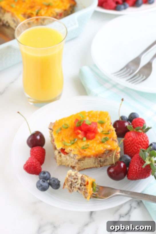 Savory Sleep-In Breakfast Bake 4 When we take a step back we see the casserole served up on a plate with fruit and a glass of orange juice.