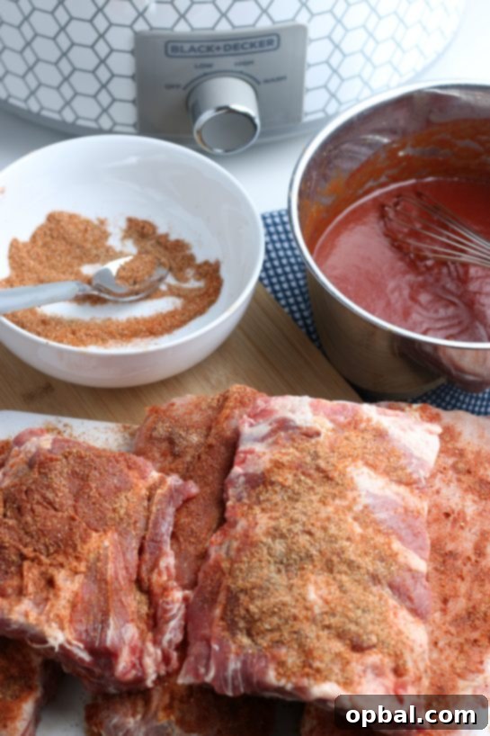 Fall-Off-The-Bone Slow Cooker BBQ Ribs 5 Generously applying a savory dry rub mixture over a rack of baby back ribs, ensuring full coverage for maximum flavor development.