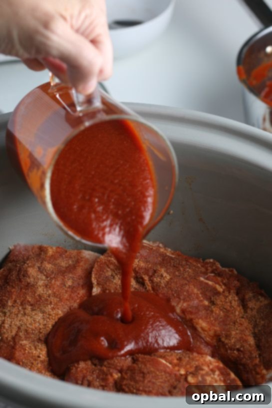 Carefully loading seasoned ribs into the slow cooker, ensuring they are well-placed before adding the sauce to begin cooking.
