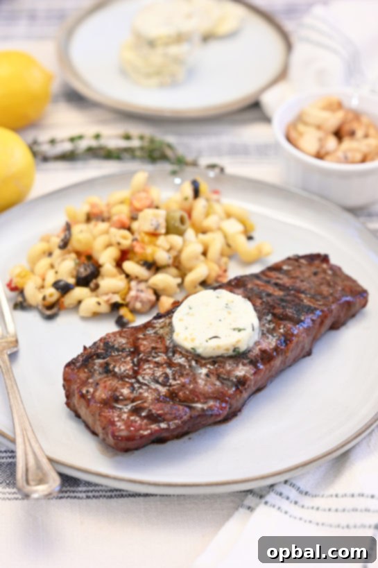 Fire-Kissed Strip Steak with Melting Herb Butter 5 Summer grilled strip steaks with herb compound butter, creating a gourmet dinner at home with intensified flavor.