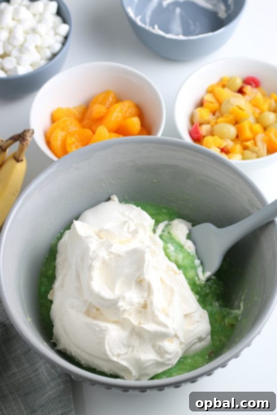 Pistachio Cloud Fruit Ambrosia 12 The moment whipped topping is added to the pistachio mixture, transforming it into a wonderfully creamy and light salad.