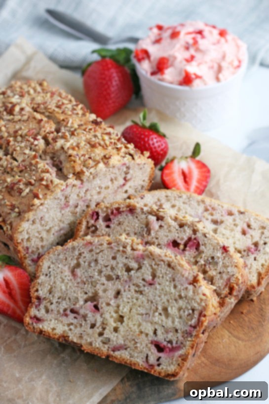 Luscious Strawberry Cream Bread 2 Sliced strawberry bread with fresh strawberries, ready to be enjoyed.