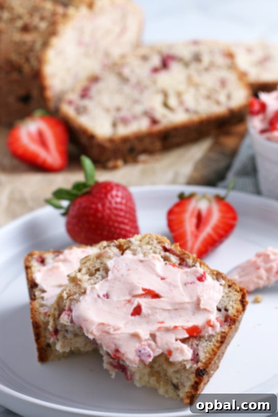 Luscious Strawberry Cream Bread 4 Close-up of a slice of strawberry bread topped with strawberry cream cheese.