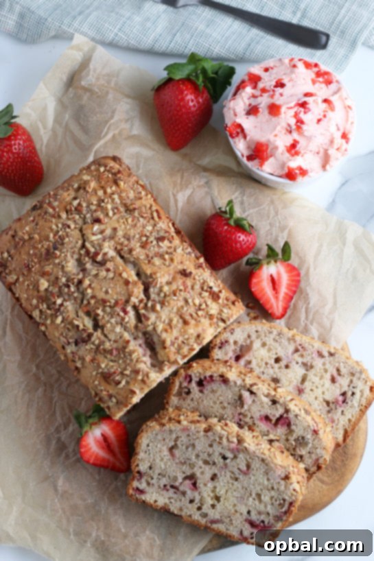 Luscious Strawberry Cream Bread 5 Overhead view of a freshly baked loaf of strawberry bread, sliced and ready to serve.