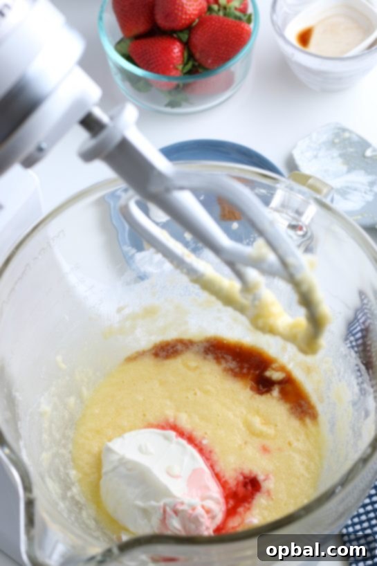 Luscious Strawberry Cream Bread 9 Additional wet ingredients, including sour cream and extracts, added to the stand mixer.