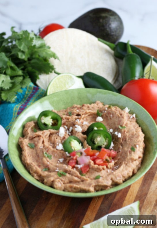 Close-up shot of homemade refried beans, showcasing their rich color and texture, better than any Mexican restaurant