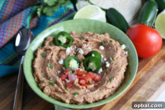 Serving of authentic homemade refried beans in a bowl, perfect for tacos or as a side