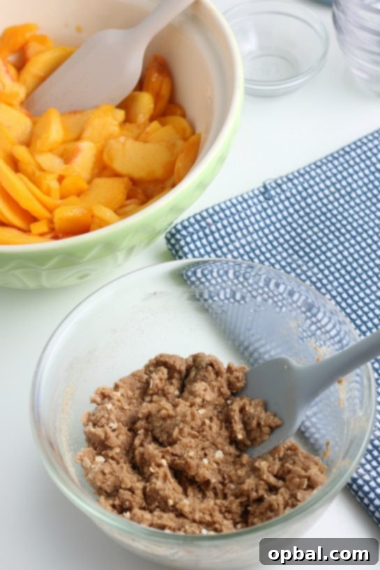 Sun-Kissed Peach Crumble 13 Mixing the dry ingredients for the crumb topping with the butter to achieve a perfect streusel consistency for the peach crisp
