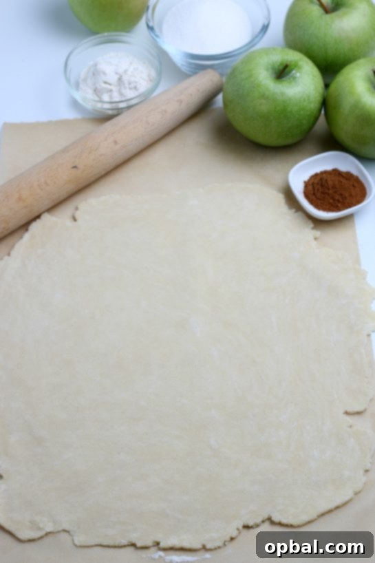 Rustic Apple Tart 11 The pie crust dough for the apple crostata, skillfully rolled out into a large, even circle on a floured surface.