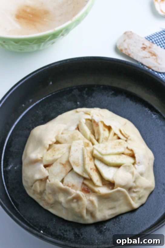 Rustic Apple Tart 15 The apple crostata fully formed with its rustic edges folded over the filling, ready to be placed into the oven for baking.