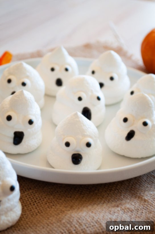 Spook-tacular Meringue Bites 2 Adorable Halloween Boo Meringues: A perfect spooky treat for kids' parties.
