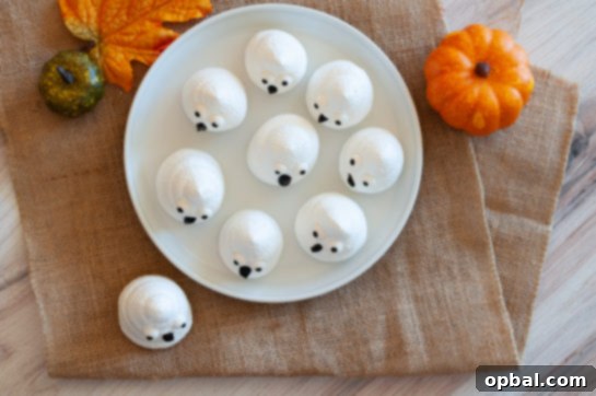 Spook-tacular Meringue Bites 3 Overhead view of a tray of freshly baked Halloween Boo Meringues.