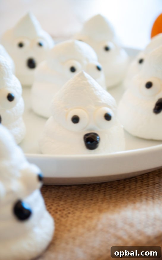 Spook-tacular Meringue Bites 9 Close-up of a delightful Halloween Boo Meringue with a hand-drawn smile.