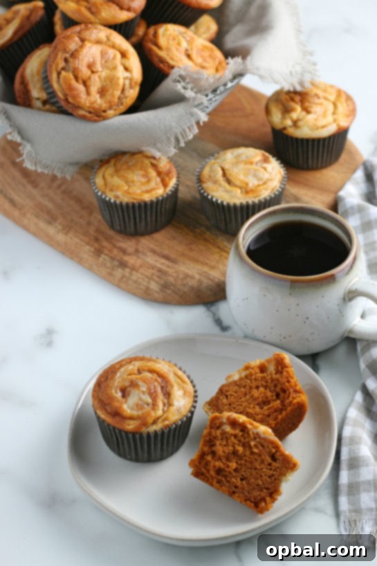 Spiced Pumpkin Cream Cheese Swirl Muffins 13 Close-up of a Pumpkin Cream Cheese Swirl Muffin with a beautifully defined swirl, ready to be enjoyed.