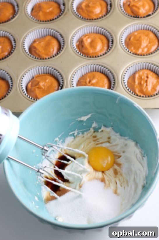 Spiced Pumpkin Cream Cheese Swirl Muffins 14 Delicious Pumpkin Cream Cheese Swirl Muffins, fresh from the oven, showcasing the beautiful marbling.