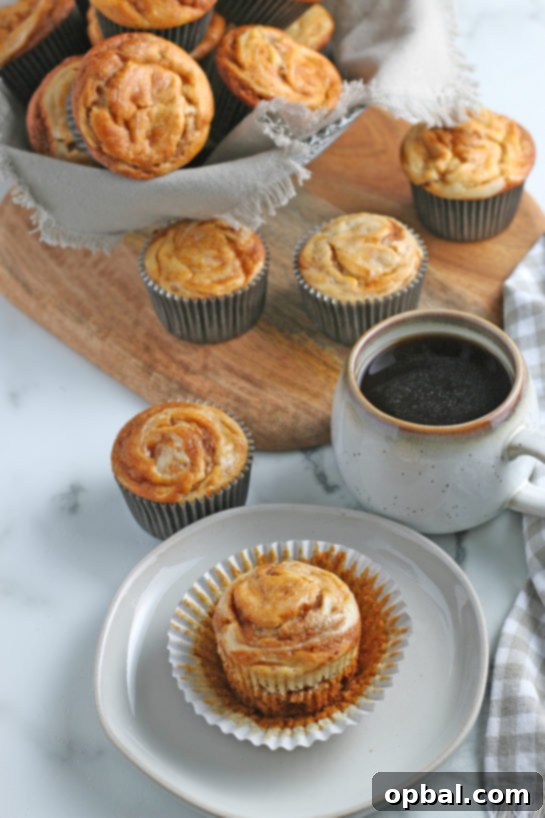 Spiced Pumpkin Cream Cheese Swirl Muffins 15 A tray of gorgeous Pumpkin Cream Cheese Swirl Muffins, baked to perfection and ready to be served.