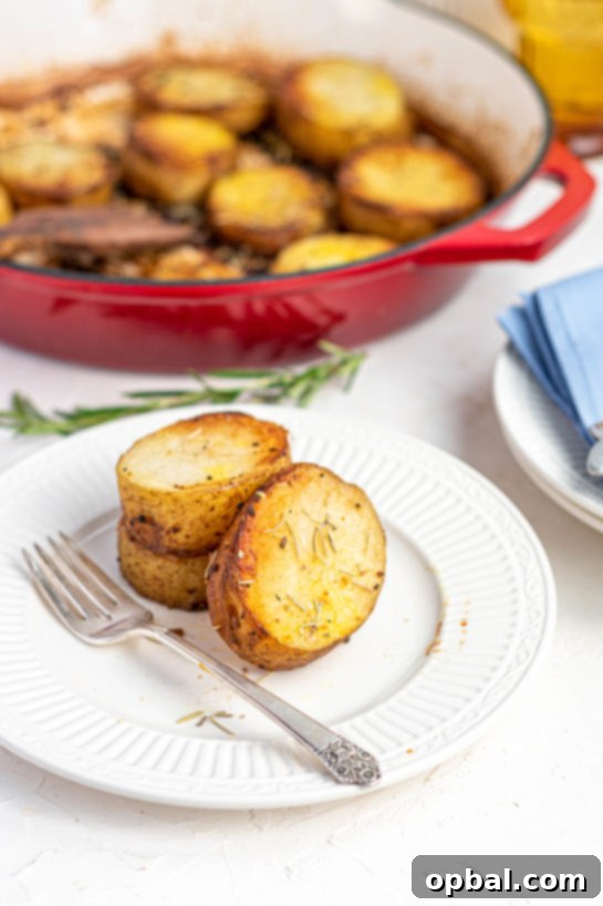 Velvet Roasted Potatoes 2 Freshly sliced Russet potatoes arranged on a baking sheet, ready for the oven.