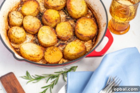 Velvet Roasted Potatoes 5 Sliced potatoes browning in a hot skillet with melted butter and rosemary.