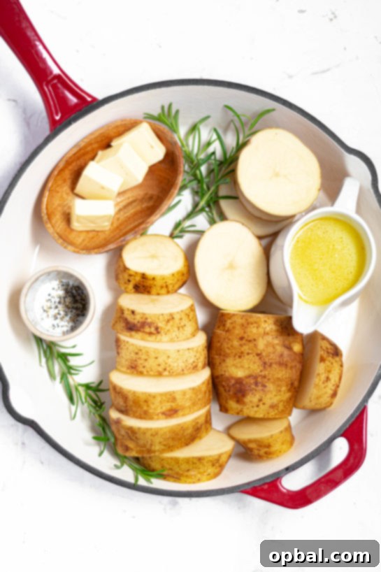 Velvet Roasted Potatoes 8 Essential ingredients for melting potatoes: Russet potatoes, butter, rosemary, garlic, and chicken broth.