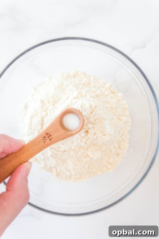 Decadent Dough Bites 7 Adding dry ingredients, flour and salt, to the wet mixture for cookie dough bombs