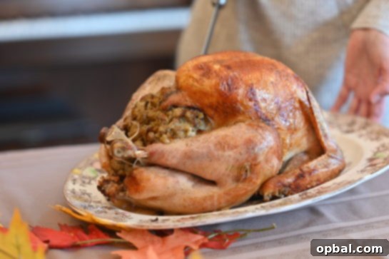 The Ultimate Classic Stuffed Turkey 6 The cooked Classic Stuffed Turkey resting on a cutting board, allowing juices to redistribute.