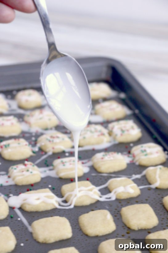 Merry Little Sugar Cookies 12 Drizzling the icing for the Christmas Sugar Cookie Bites recipe