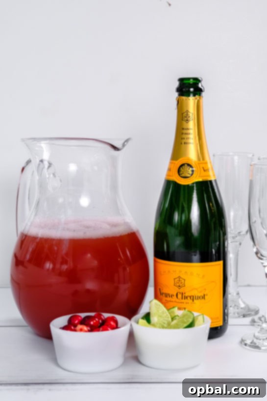 Festive Mimosas 4 An open bottle of champagne, poised and ready to be poured into flutes for a celebratory batch of Holiday Mimosas.