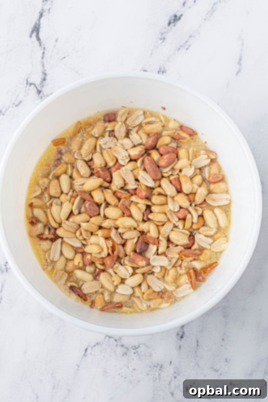 Quick Microwave Peanut Brittle 7 Adding the roasted peanuts needed to make the Microwave Peanut Brittle recipe