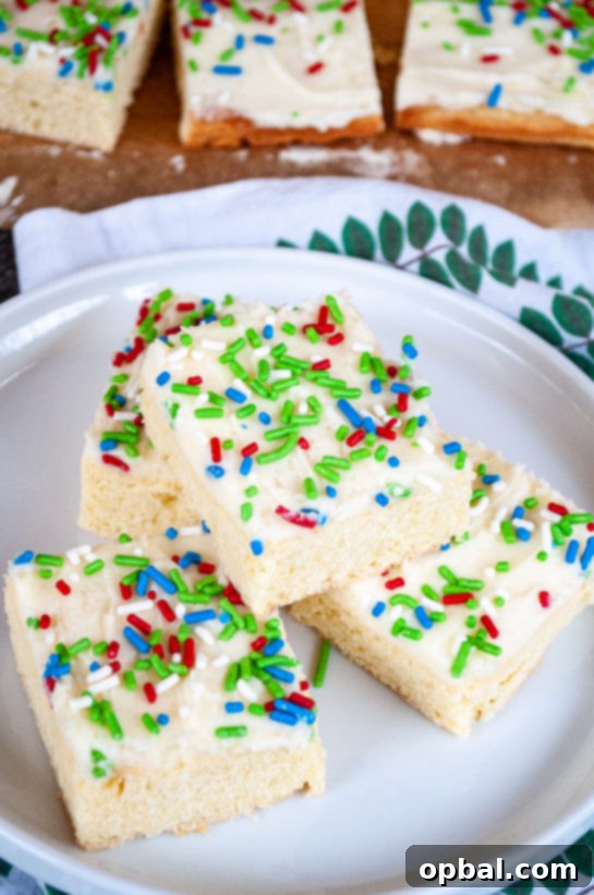 Sparkling Holiday Sugar Cookie Bars 4 Overhead shot of freshly baked and frosted Holiday Sugar Cookie Bars on a plate