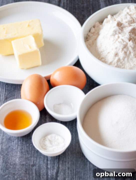 Sparkling Holiday Sugar Cookie Bars 5 Ingredients laid out for making sugar cookie bars: butter, sugar, eggs, flour, vanilla, baking powder, salt