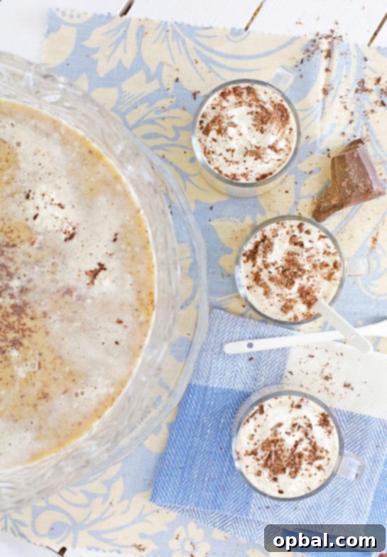 Effortless Iced Coffee Punch 2 A vibrant coffee punch brimming in a elegant punch bowl, garnished with whipped cream and chocolate shavings, ready for a festive holiday celebration.