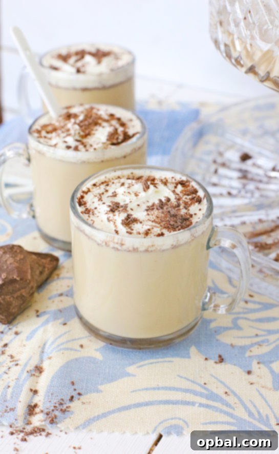 Effortless Iced Coffee Punch 3 A top-down view of the frothy coffee punch in a clear glass bowl, showcasing its inviting texture and festive appeal.