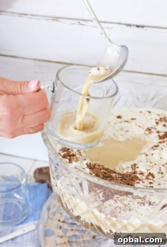 Effortless Iced Coffee Punch 10 Individual glasses filled with the frothy coffee punch, topped with whipped cream and chocolate, showcasing perfect serving presentation.