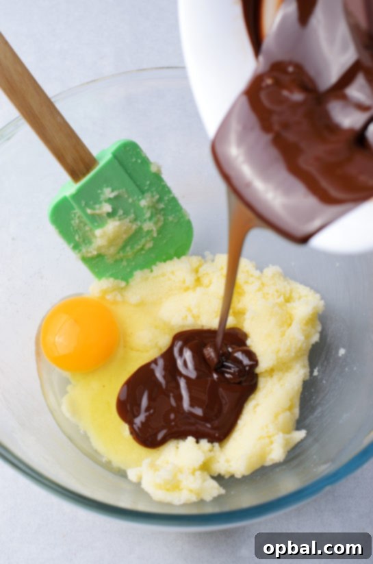Pouring the melted chocolate for the chocolate hazelnut crinkle cookies recipe