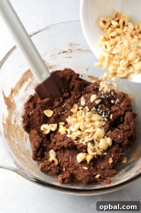 Mixing in the crushed hazelnuts for the chocolate hazelnut crinkle cookies recipe