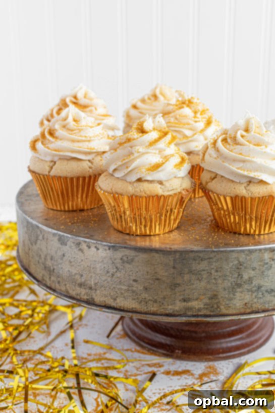 New Years Eve Bubbly Cupcakes 2 Celebration Champagne Cupcakes recipe is perfect for birthdays, Mother's Day brunch or a New Year’s Eve dessert! They are jazzed up with gold sprinkles to add some glam!