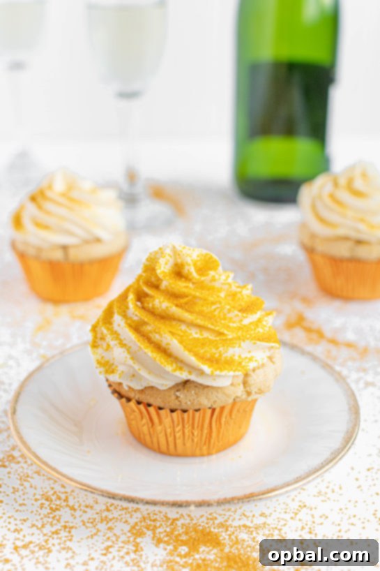 New Years Eve Bubbly Cupcakes 7 Photo of the plated finished Champagne Cupcakes recipe topped with the gold sprinkles for New Year's Eve or Mother's Day