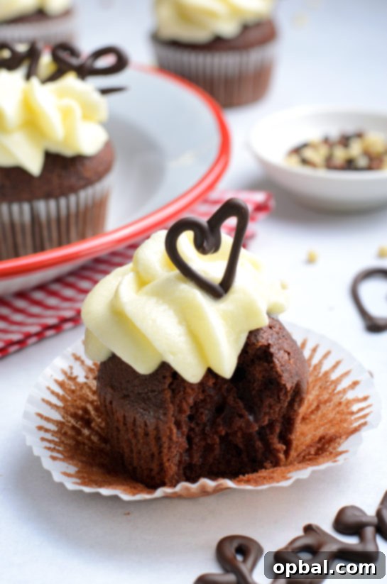Velvet Chocolate Romance Cupcakes 15 Lover's Chocolate Cupcake with a bite taken, revealing its moist interior