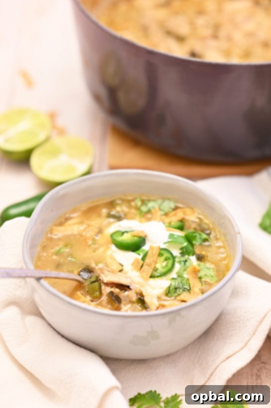 Creamy White Chicken Chili 4 Close-up of a bowl of White Chicken Chili with vibrant toppings