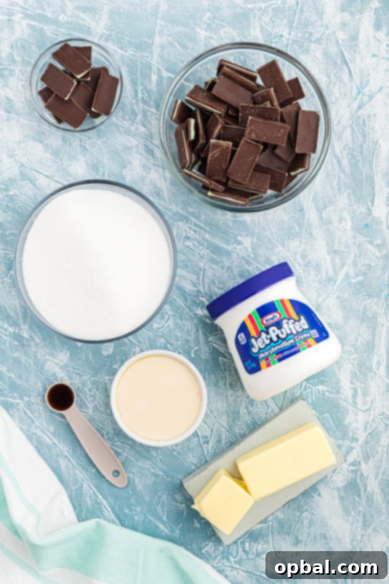 Decadent Andes Mint Fudge 6 A collection of ingredients for Andes Mint Fudge, including sugar, butter, evaporated milk, marshmallow creme, and Andes Mints.