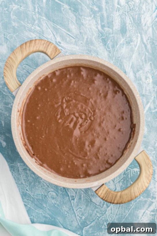 Decadent Andes Mint Fudge 9 Melting Andes Mints in a bowl, ready to be incorporated into the hot fudge mixture.