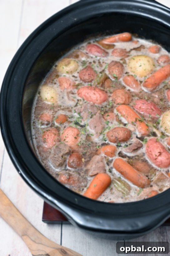 Effortless Slow Cooker Beef Stew 2 This Crock Pot Beef Stew recipe features chunks of tender beef cooked with onions and vegetables in a rich, aromatic sauce, perfect for ultimate comfort!