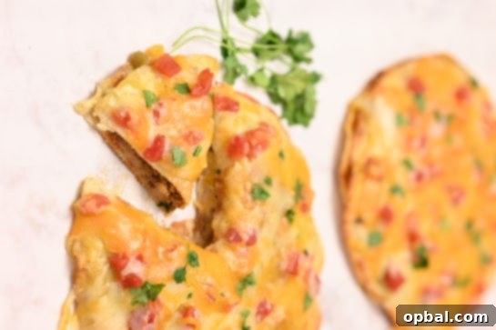 DIY Taco Bell Mexican Pizza Perfection 5 Four individual homemade Mexican Pizzas cooling on a wire rack after baking, showing the rich red enchilada sauce and melted cheese.