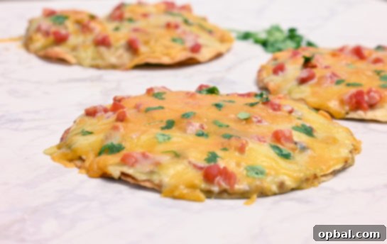 DIY Taco Bell Mexican Pizza Perfection 6 Closeup shot of a ready-to-eat homemade Mexican Pizza slice, showing the crisp tortilla, seasoned beef, and melted cheese, with fresh tomato garnish.