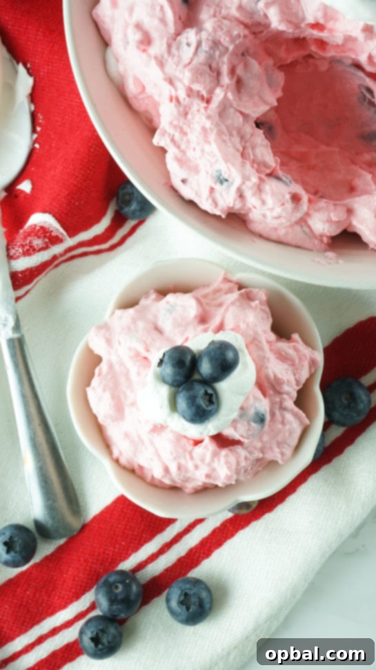 Stars and Stripes Fluff Bliss 10 Another overhead view of an individual serving of Patriotic Red White and Blue Fluff Salad in a bowl.