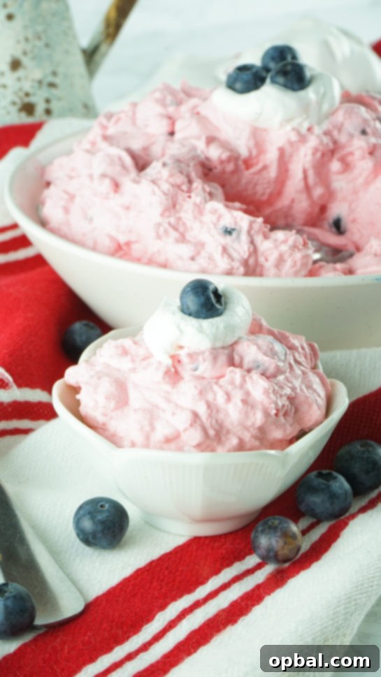Stars and Stripes Fluff Bliss 6 Individual serving of patriotic Red White and Blue Fluff Salad in a clear bowl, showcasing its festive layers.