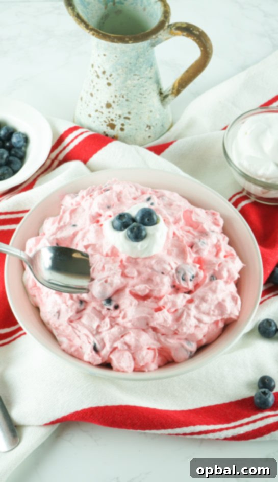 Stars and Stripes Fluff Bliss 8 Full bowl of easy Patriotic Red White and Blue Fluff Salad, perfect for any summer party or potluck gathering.