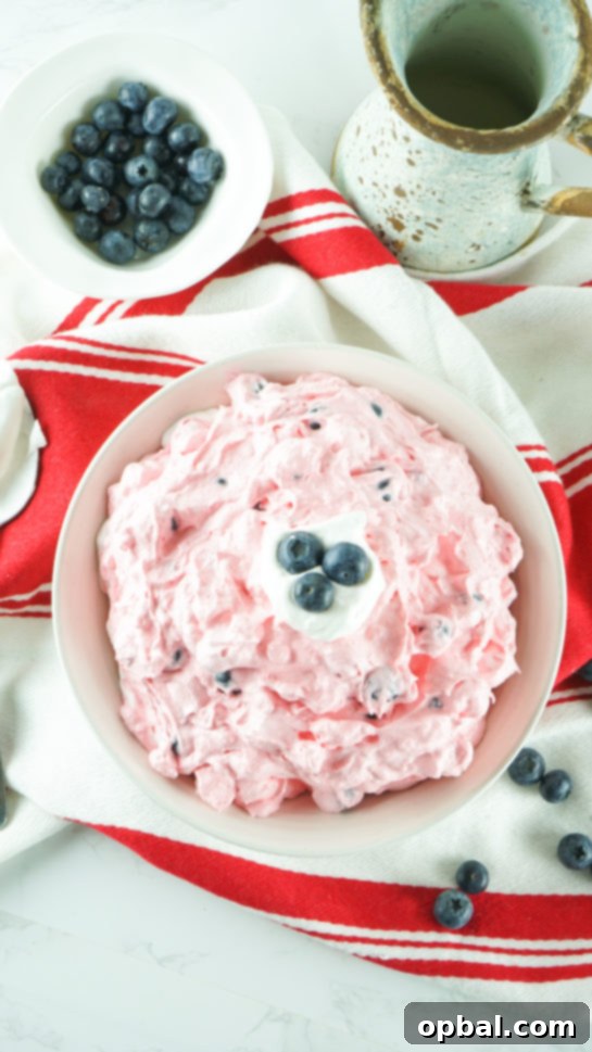 Stars and Stripes Fluff Bliss 9 Overhead shot of the patriotic Red White and Blue Fluff Salad recipe, featuring fresh berries and marshmallows.