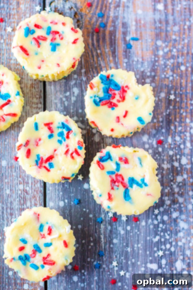 Star-Spangled Mini Cheesecakes 4 Red, White, and Blue Mini Cheesecakes recipe layered with a Golden Oreo crust and creamy tangy cheesecake. Top with sprinkles and whipped cream for the perfect dessert for 4th of July!