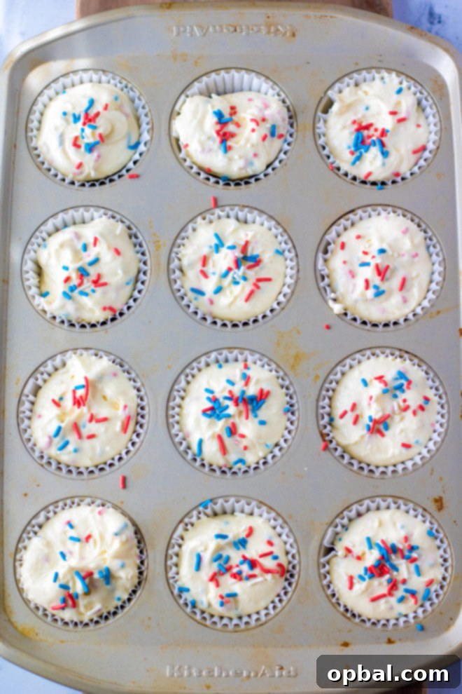 Star-Spangled Mini Cheesecakes 10 Red, White, and Blue Mini Cheesecakes Recipe ready to go in the oven with the sprinkles on top